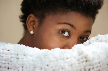Close up portrait of a young black woman covering faceの写真素材
