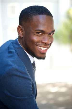 Close up portrait of a charming young businessman sitting outsideの写真素材