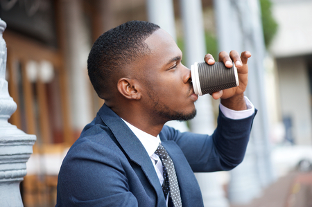 Close up portrait of a businessman relaxing with a cup of coffee during a breakの写真素材
