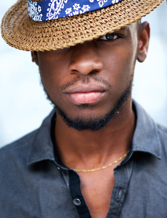 Close up portrait of stylish young african american man with hat