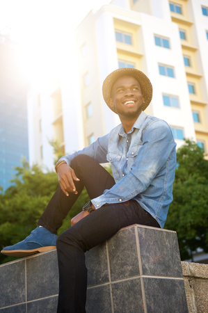 Portrait of a happy man sitting in the cityの写真素材