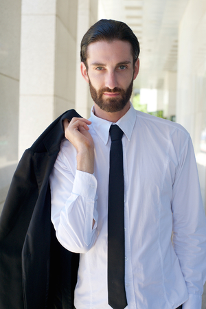 Portrait of a cool businessman with beard and black tieの写真素材