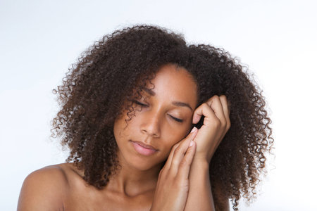 Close up portrait of a beautiful young african american woman sleepingの写真素材
