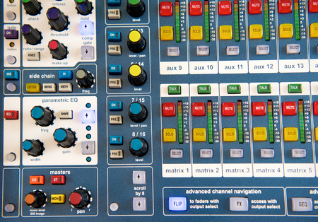 Close up buttons and knobs on stereo audio mixer