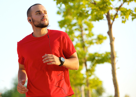 Young man enjoying a run outdoors keeping in shape
