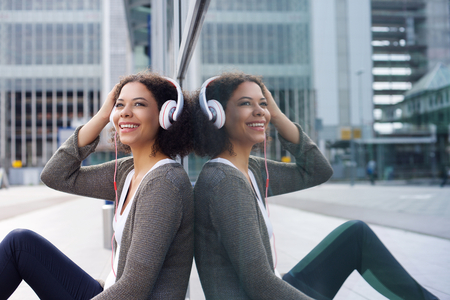 Close up portrait of an african american girl listening to music on headphonesの写真素材
