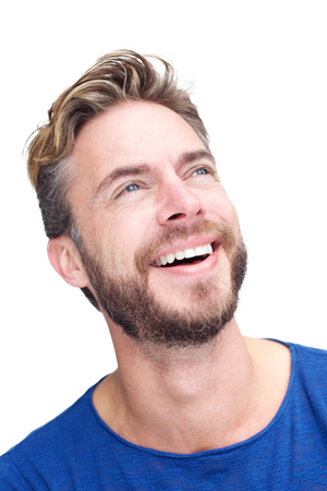 Close up portrait of a male fashion model with beard laughing and looking upの写真素材