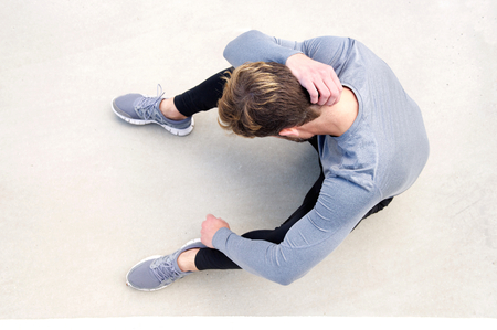 Portrait from above man in pain after workoutの写真素材