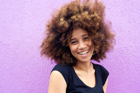 Close up portrait of a laughing african american woman with afroの写真素材