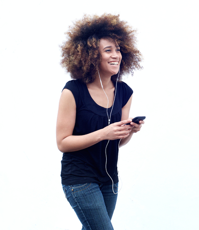 Portrait of smiling african american woman listening to music on headphones
