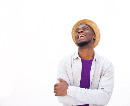 Portrait of a stylish young african man laughing against white backgroundの写真素材