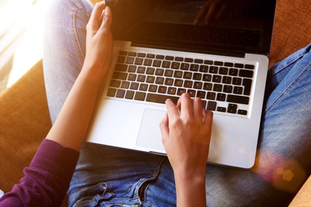Young woman hands working on laptop from aboveの写真素材