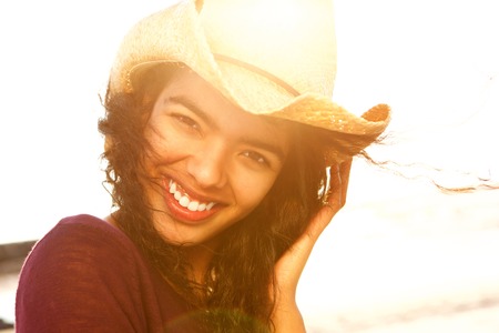 Close up portrait of a beautiful fashion model smiling with hatの写真素材