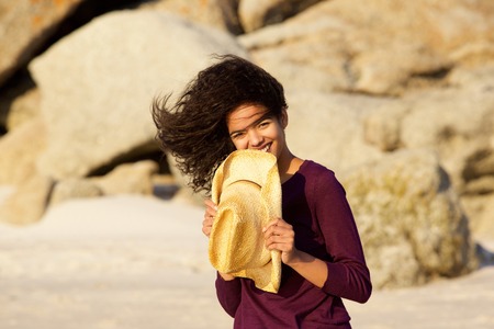 Portrait of a smiling young black woman at the beachの写真素材
