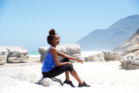 Portrait of female runner relaxing at the beachの写真素材