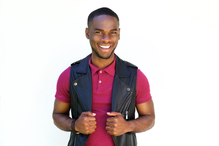 Portrait of handsome young  african guy smiling in black leather jacket on white backgroundの写真素材