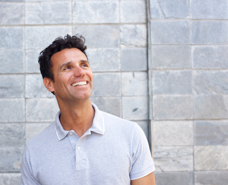 Close up portrait of older guy smiling and looking awayの写真素材