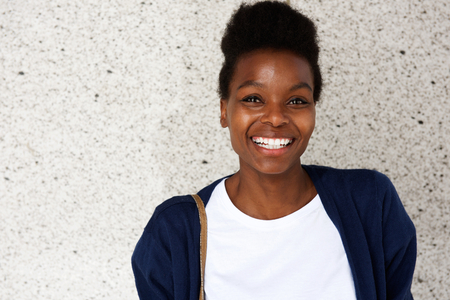 Close up portrait of attractive young african woman looking happyの写真素材