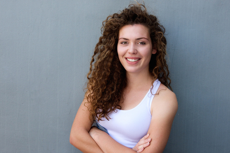 Portrait of smiling teen standing with arms crossed
