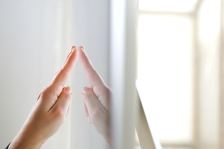 Close up portrait of finger pointing at computer screenの写真素材