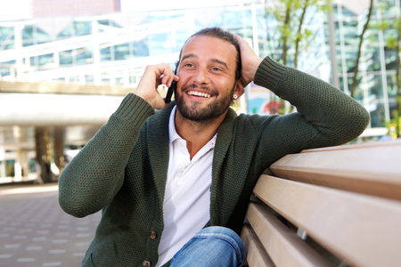 Portrait of surprised man with hand to head talking on phoneの写真素材