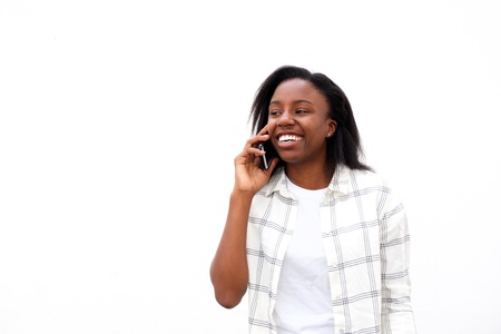 Portrait of happy african woman having nice phone conversation.の写真素材