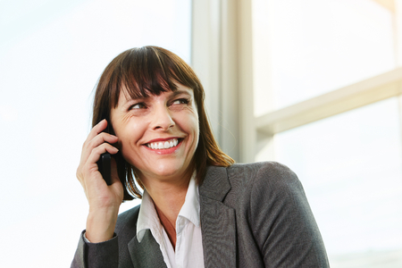 Close up portrait of beautiful business woman on professional phone callの写真素材