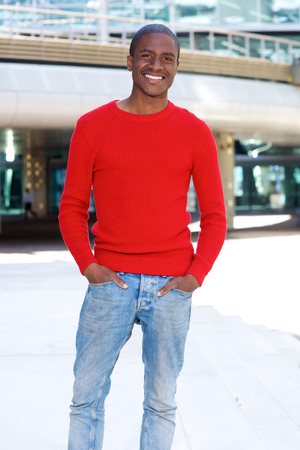 Portrait of cool african american man smiling in the cityの写真素材