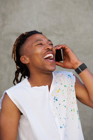 Portrait of african man  laughing and talking on cellphoneの写真素材