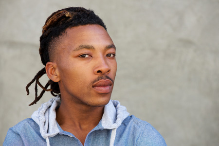 Close up portrait of african man with dreadlocks looking at cameraの写真素材