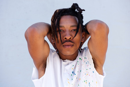 Close up portrait of young black man with dreadlocks staringの写真素材
