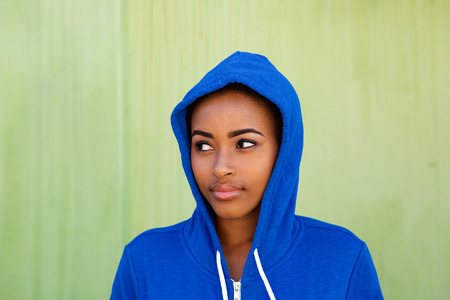 Close up portrait of beautiful young black woman glancing awayの写真素材