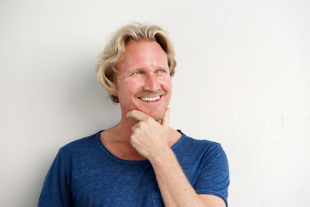 Portrait of handsome man smiling and looking awayの写真素材