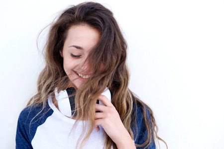 Close up portrait of beautiful young woman with headphones laughingの写真素材