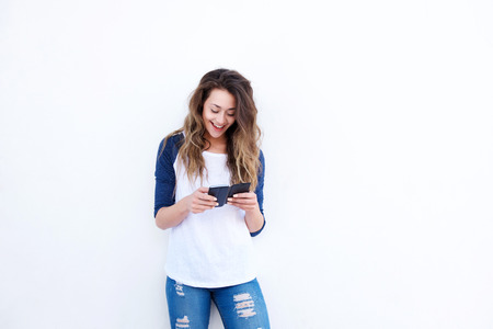 Portrait of happy young woman using smart phone