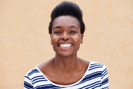 Close up portrait of smiling young black womanの写真素材