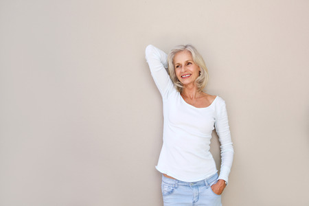 Portrait of carefree happy older woman with hand to head