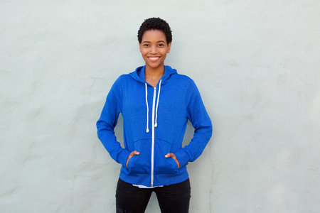 Portrait of attractive young african american woman smiling with blue sweatshirt