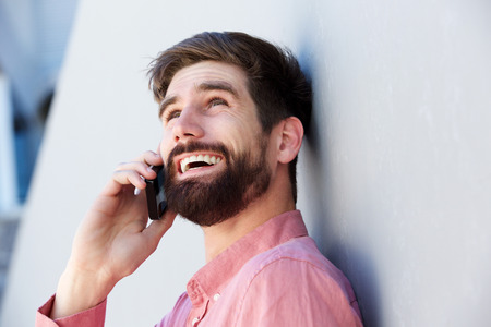 Close up portrait of happy businessman talking on mobile phone