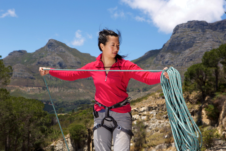 Portrait of asian female climber on the peak folding rope.の写真素材
