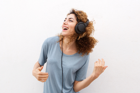 Portrait of smiling young woman listening to music with headphonesの写真素材
