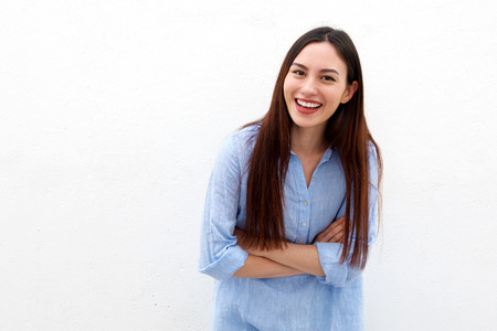 Portrait of laughing woman with long hair and arms crossedの写真素材
