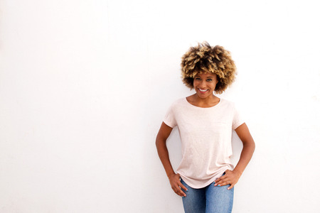 Portrait of attractive black woman standing against white backgroundの写真素材