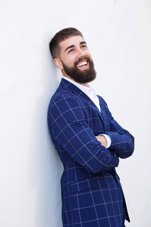 Portrait of laughing businessman standing with arms crossedの写真素材