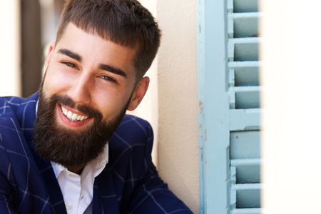Close up portrait of happy successful businessman sitting outsideの写真素材
