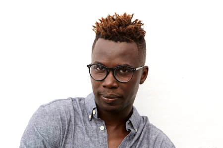 Close up portrait of serious african man with glasses against white background