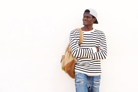 Portrait of handsome young African American student leaning against wall  の写真素材
