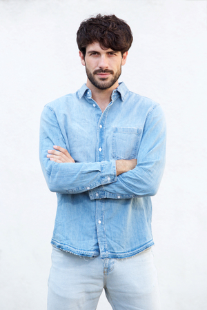 Portrait of attractive young man with beard in front of white backgroundの写真素材