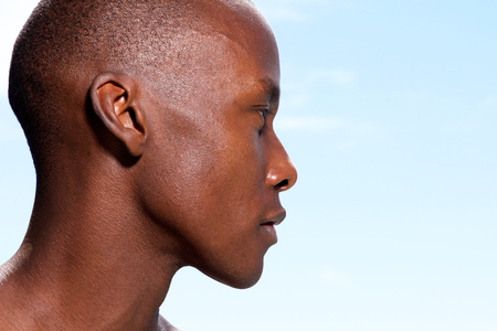 Close up profile portrait of handsome african american man staringの写真素材