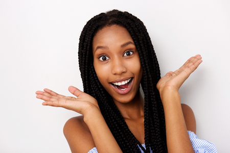 Close up portrait of young african woman looking surprised on white backgroundの写真素材